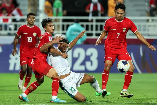 Pemain Timnas Indonesia U-23 Ivar Jenner berebut bola dengan pemain Timnas Irak U-23 Karar Mohammed pada pertandingan perebutan tempat ketiga Piala Asia U-23 2024 di Stadion Abdullah bin Khalifa, Kamis (2/5/2024). Foto: KARIM JAAFAR/AFP