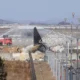 Image Credit AP/AP - Puing-puing pesawat Boeing 737-800 yang dioperasikan oleh maskapai hemat Korea Selatan Jeju Air tergeletak di Bandara Internasional Muan di Muan, Korea Selatan, Selasa, 31 Desember 2024.